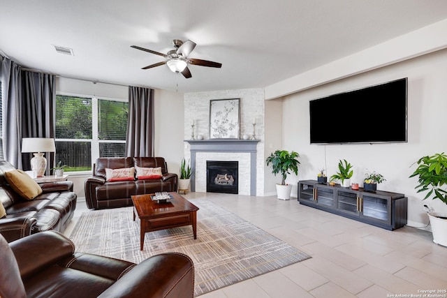 20607 Wild Spgs, San Antonio, TX 78258 - living area with a ceiling fan and a stone fireplace