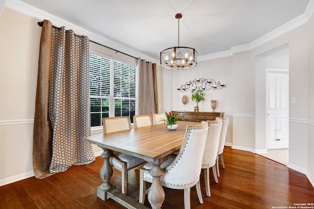 20607 Wild Spgs, San Antonio, TX 78258 - dining space with a chandelier, wood finished floors, baseboards, and ornamental molding