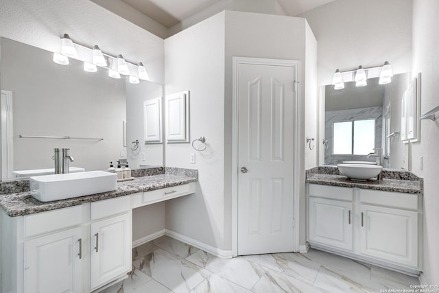 20607 Wild Spgs, San Antonio, TX 78258 - full bath with marble finish floors, two vanities, and baseboards