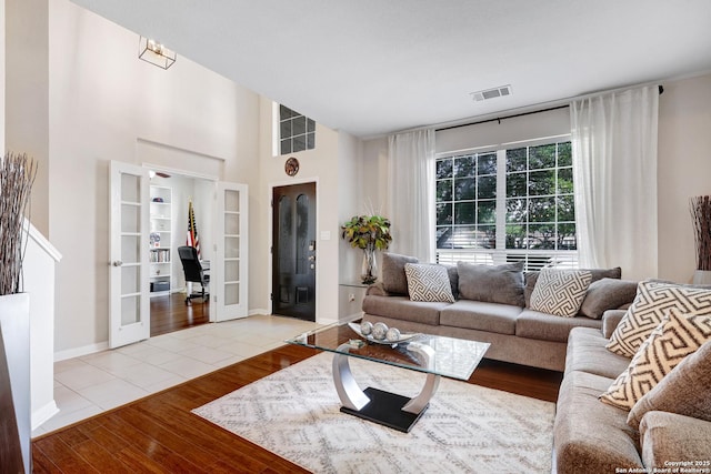 20607 Wild Spgs, San Antonio, TX 78258 - living area with wood finished floors, french doors, baseboards, and a high ceiling