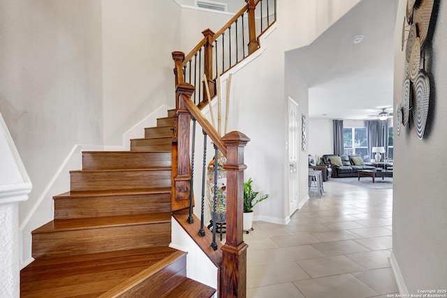 20607 Wild Spgs, San Antonio, TX 78258 - stairs with baseboards, tile patterned flooring, a towering ceiling, and ceiling fan