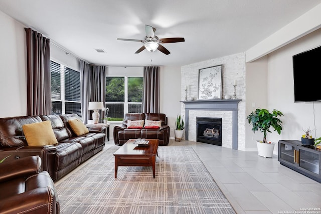 20607 Wild Spgs, San Antonio, TX 78258 - living area with a ceiling fan, a stone fireplace, and tile patterned floors