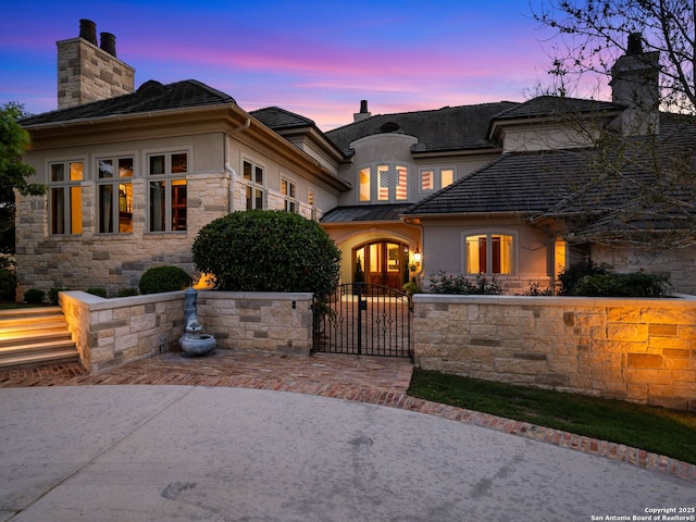 52 Oakland Hls, Boerne, TX 78006 - french provincial home with a chimney, stucco siding, a gate, and stone siding