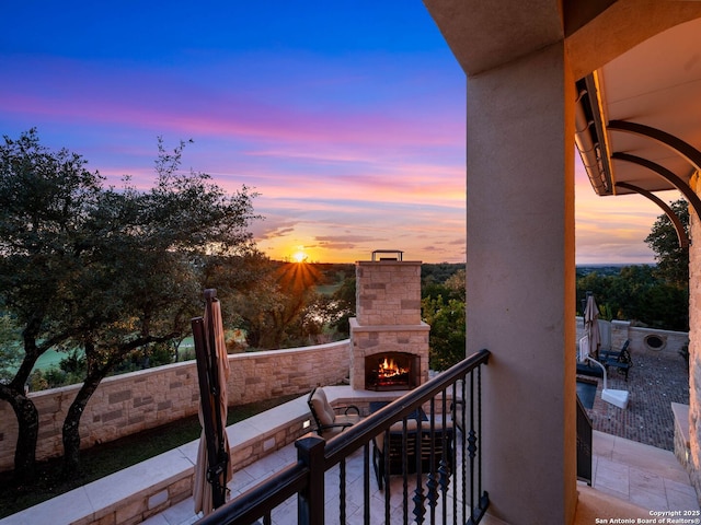 52 Oakland Hls, Boerne, TX 78006 - balcony at dusk with an outdoor stone fireplace