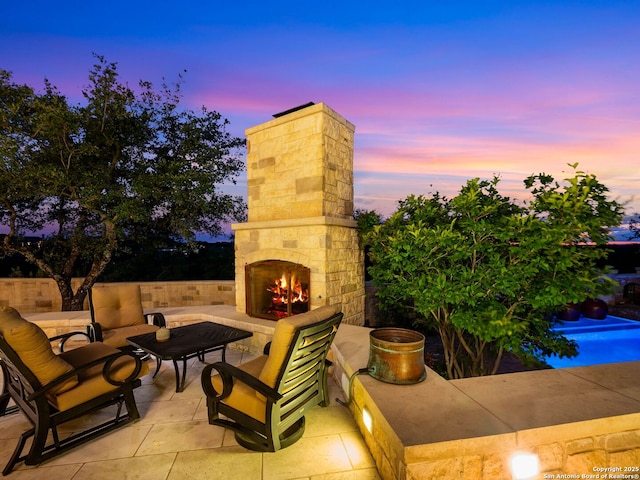 52 Oakland Hls, Boerne, TX 78006 - patio terrace at dusk with an outdoor living space with a fireplace