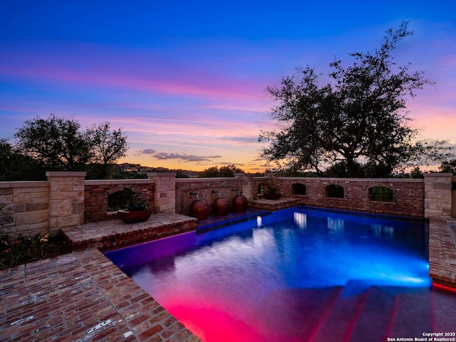 52 Oakland Hls, Boerne, TX 78006 - pool at dusk with a patio