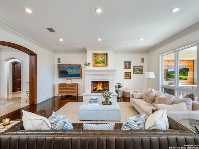 52 Oakland Hls, Boerne, TX 78006 - living room with arched walkways, wood finished floors, recessed lighting, a warm lit fireplace, and baseboards
