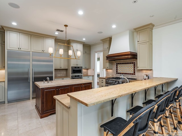 52 Oakland Hls, Boerne, TX 78006 - kitchen featuring premium range hood, high end appliances, tasteful backsplash, a kitchen island, and recessed lighting