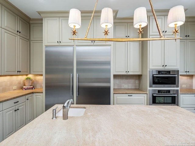 52 Oakland Hls, Boerne, TX 78006 - kitchen with appliances with stainless steel finishes, backsplash, a sink, pendant lighting, and light stone countertops