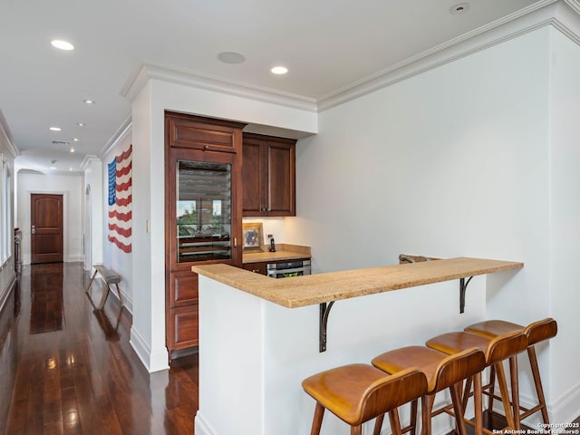 52 Oakland Hls, Boerne, TX 78006 - bar with dark wood finished floors, ornamental molding, baseboards, recessed lighting, and wine cooler