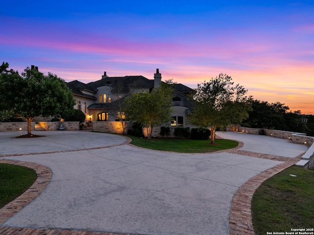 52 Oakland Hls, Boerne, TX 78006 - french country style house featuring curved driveway, a chimney, and a yard