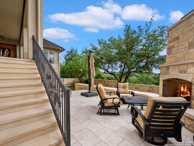52 Oakland Hls, Boerne, TX 78006 - view of patio with stairway and an outdoor living space with a fireplace