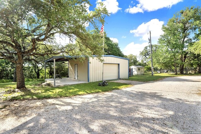 661 Abels Way, Canyon Lake, TX 78133 - garage with gravel driveway and a detached garage