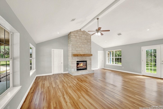 661 Abels Way, Canyon Lake, TX 78133 - unfurnished living room with light wood-style floors, a ceiling fan, a stone fireplace, high vaulted ceiling, and beamed ceiling