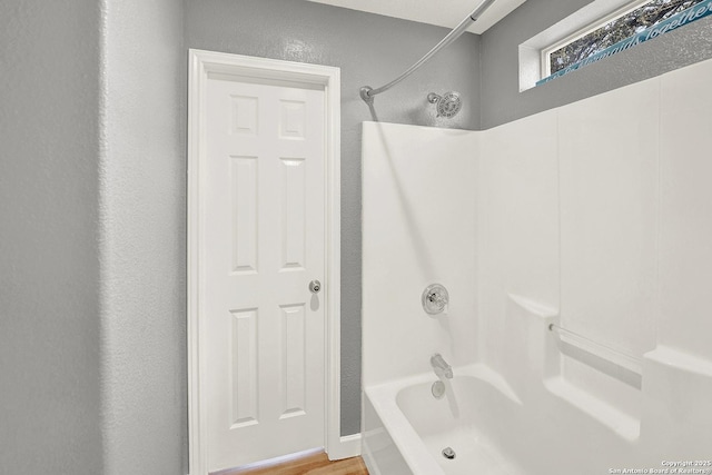 661 Abels Way, Canyon Lake, TX 78133 - bathroom featuring bathtub / shower combination and wood finished floors