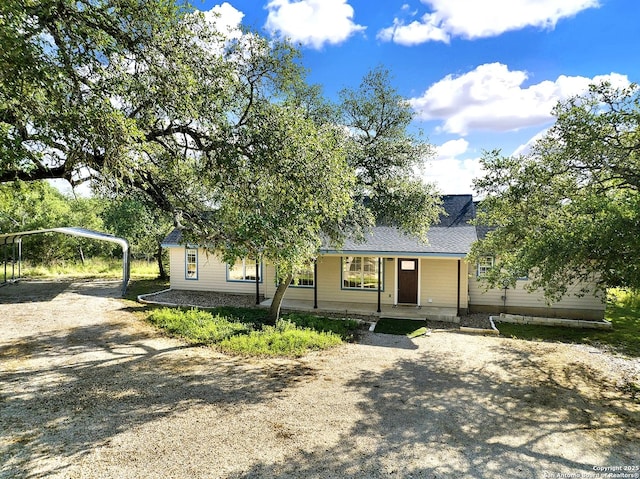 661 Abels Way, Canyon Lake, TX 78133 - ranch-style home with driveway, a porch, and a detached carport
