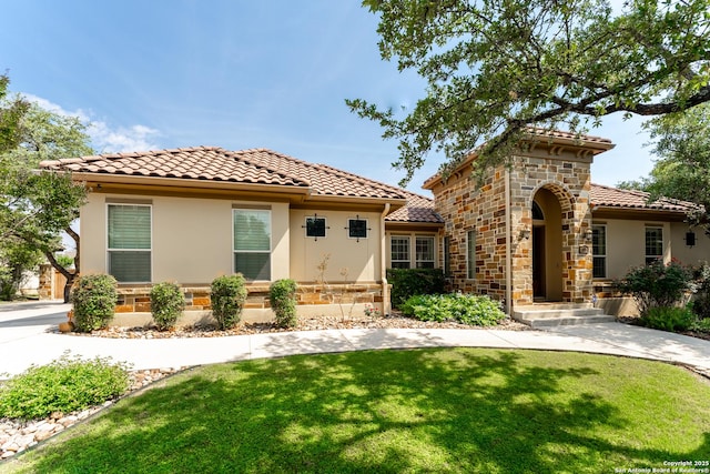 135 Penns Way, Shavano Park, TX 78231 - mediterranean / spanish house with a tile roof, stucco siding, a front lawn, and stone siding