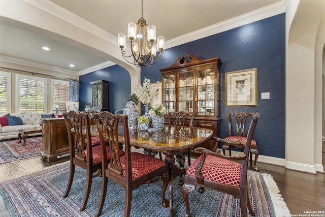 135 Penns Way, Shavano Park, TX 78231 - dining area with arched walkways, a chandelier, wood finished floors, crown molding, and baseboards