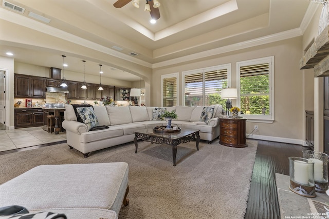 135 Penns Way, Shavano Park, TX 78231 - living room featuring arched walkways, a tray ceiling, ceiling fan, baseboards, and ornamental molding