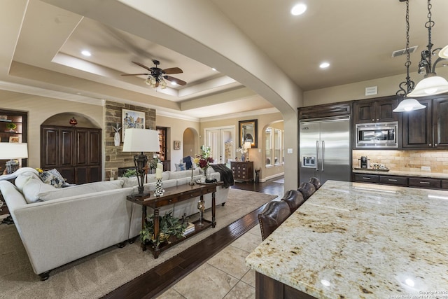 135 Penns Way, Shavano Park, TX 78231 - living area with arched walkways, ceiling fan, a raised ceiling, recessed lighting, and ornamental molding