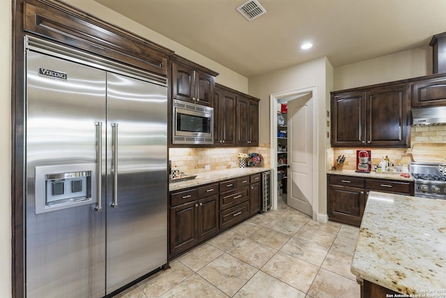 135 Penns Way, Shavano Park, TX 78231 - kitchen with built in appliances, ventilation hood, dark brown cabinets, backsplash, and wine cooler