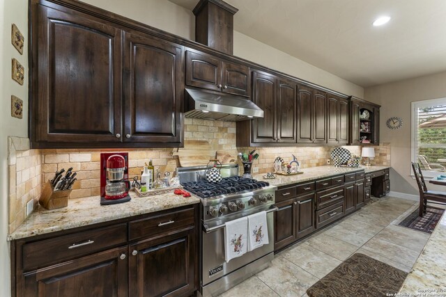 135 Penns Way, Shavano Park, TX 78231 - kitchen featuring designer range, under cabinet range hood, dark brown cabinets, decorative backsplash, and light stone countertops