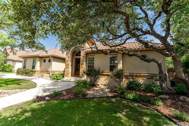 135 Penns Way, Shavano Park, TX 78231 - mediterranean / spanish home with a tile roof, stucco siding, and a front lawn