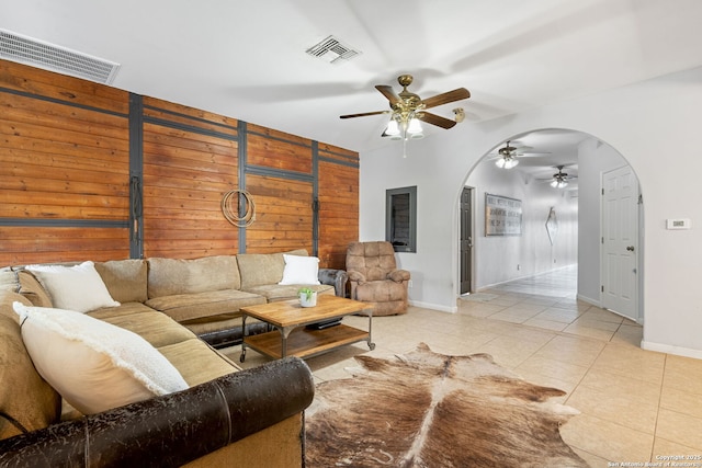 25 Zoeller Ln, Boerne, TX 78006 - living area with arched walkways, ceiling fan, light tile patterned floors, baseboards, and wood walls