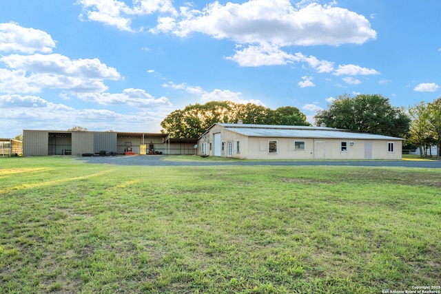 25 Zoeller Ln, Boerne, TX 78006 - rear view of property with a pole building, a lawn, and an outbuilding