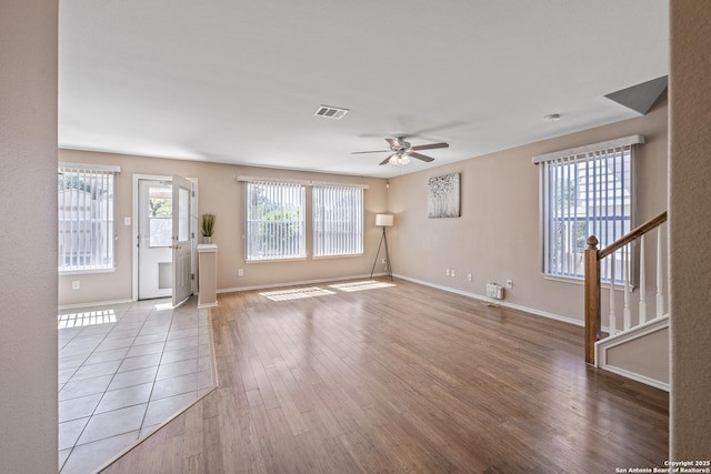 1427 Alaskan Wolf, San Antonio, TX 78245 - unfurnished living room with ceiling fan, stairs, wood finished floors, and baseboards