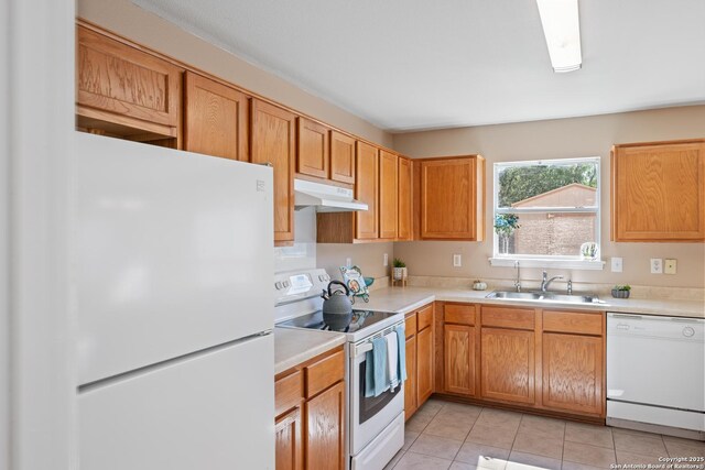 1427 Alaskan Wolf, San Antonio, TX 78245 - kitchen featuring white appliances, a sink, under cabinet range hood, light countertops, and light tile patterned flooring