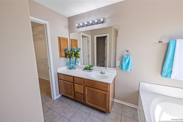 1427 Alaskan Wolf, San Antonio, TX 78245 - bathroom with vanity, tile patterned flooring, a spacious closet, and baseboards