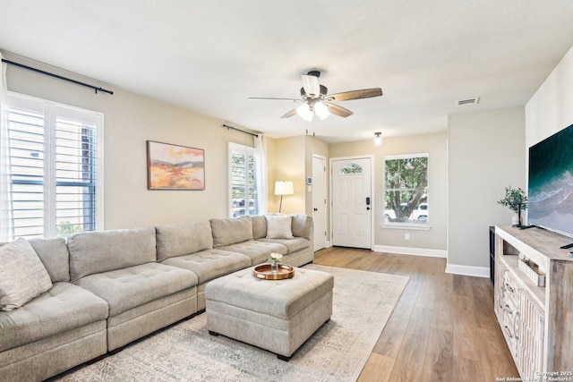 6438 Candleview Ct, San Antonio, TX 78244 - living area featuring ceiling fan, baseboards, and light wood-style floors
