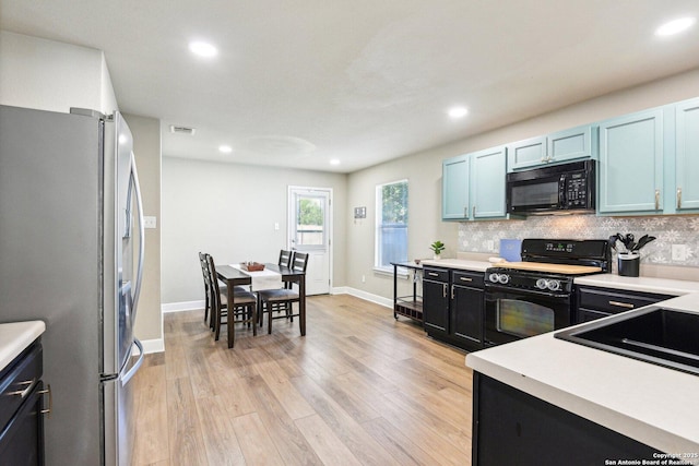 6438 Candleview Ct, San Antonio, TX 78244 - kitchen with black appliances, tasteful backsplash, light wood-style floors, light countertops, and recessed lighting