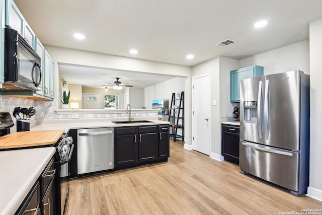 6438 Candleview Ct, San Antonio, TX 78244 - kitchen featuring black appliances, a sink, light countertops, a peninsula, and recessed lighting