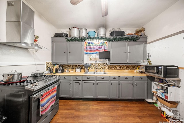 2332 Houston, San Antonio, TX 78202 - kitchen featuring a sink, stainless steel appliances, gray cabinets, wall chimney exhaust hood, and dark wood finished floors