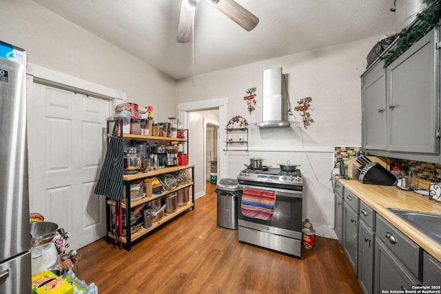 2332 Houston, San Antonio, TX 78202 - kitchen with stainless steel appliances, wall chimney range hood, gray cabinets, dark wood-type flooring, and light countertops