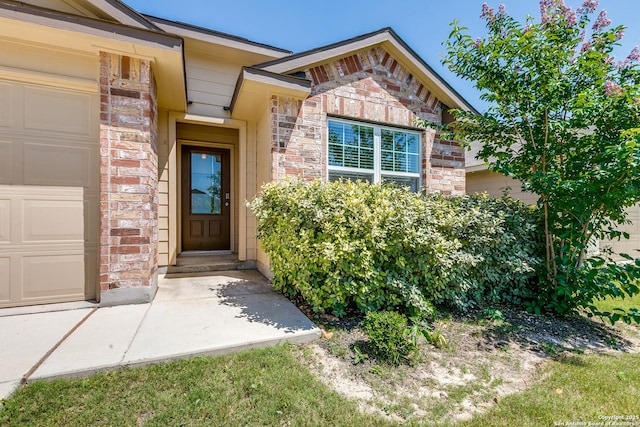 9614 Tupelo Holw, San Antonio, TX 78254 - view of exterior entry with an attached garage, brick siding, and stone siding