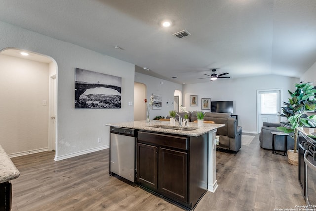 9614 Tupelo Holw, San Antonio, TX 78254 - kitchen with arched walkways, stainless steel dishwasher, a sink, ceiling fan, and dark brown cabinetry