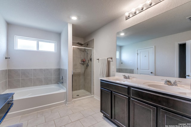 9614 Tupelo Holw, San Antonio, TX 78254 - bathroom featuring tile patterned flooring, a bath, a shower stall, double vanity, and recessed lighting