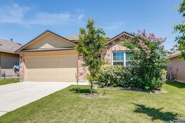 9614 Tupelo Holw, San Antonio, TX 78254 - view of front facade featuring concrete driveway, a garage, a front yard, and brick siding