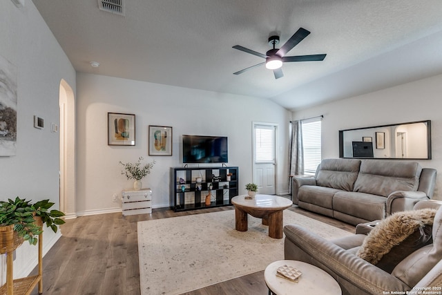 9614 Tupelo Holw, San Antonio, TX 78254 - living room with arched walkways, wood finished floors, ceiling fan, baseboards, and vaulted ceiling