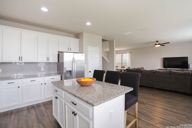 12890 Limestone Way, San Antonio, TX 78253 - kitchen featuring stainless steel fridge, dark wood-style flooring, a breakfast bar, a center island, and recessed lighting
