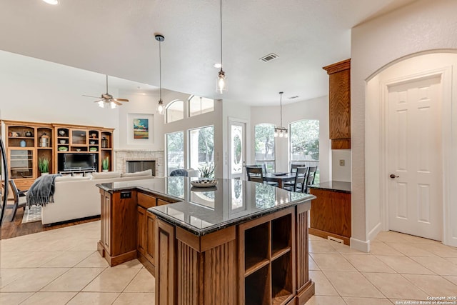 132 Long Bow Rd, Shavano Park, TX 78231 - kitchen featuring light tile patterned floors, ceiling fan, brown cabinets, and pendant lighting