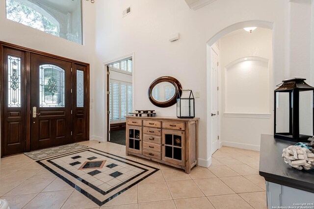 132 Long Bow Rd, Shavano Park, TX 78231 - foyer featuring arched walkways, light tile patterned flooring, baseboards, and a towering ceiling