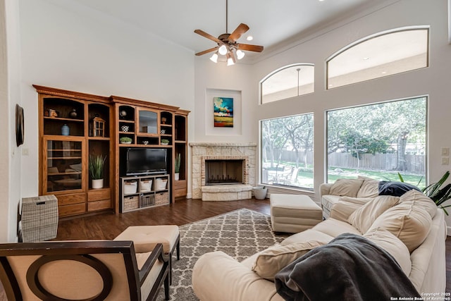 132 Long Bow Rd, Shavano Park, TX 78231 - living area with a ceiling fan, wood finished floors, a fireplace, plenty of natural light, and a high ceiling