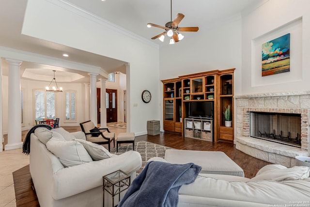 132 Long Bow Rd, Shavano Park, TX 78231 - living area featuring decorative columns, ornamental molding, a chandelier, ceiling fan, and a stone fireplace