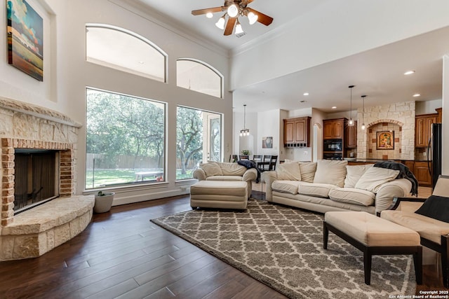 132 Long Bow Rd, Shavano Park, TX 78231 - living area featuring a ceiling fan, ornamental molding, a fireplace, a towering ceiling, and dark wood-style floors