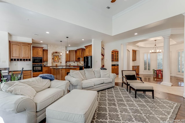 132 Long Bow Rd, Shavano Park, TX 78231 - living area with decorative columns, wood finished floors, a chandelier, recessed lighting, and ornamental molding