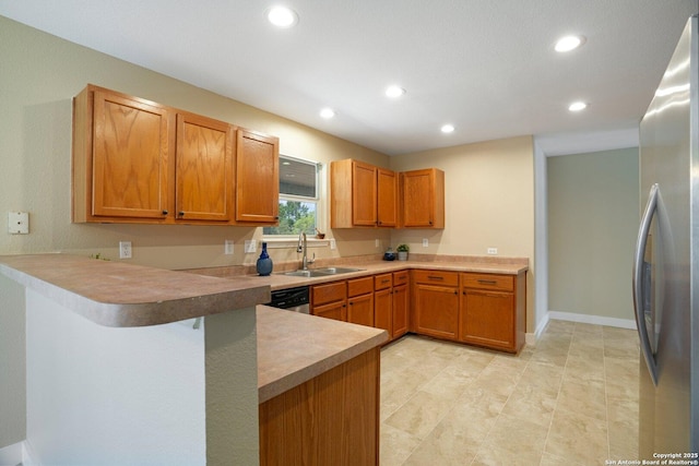 7230 Sunrise Lk, San Antonio, TX 78244 - kitchen featuring a sink, stainless steel appliances, recessed lighting, a peninsula, and brown cabinetry